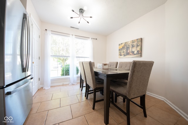 dining space featuring an inviting chandelier and light tile patterned floors