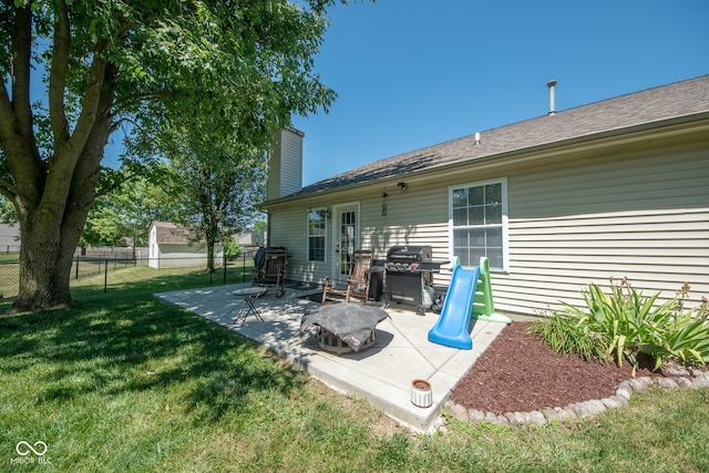 back of property with a patio area and a lawn