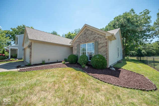 view of front of property featuring a front yard and a garage