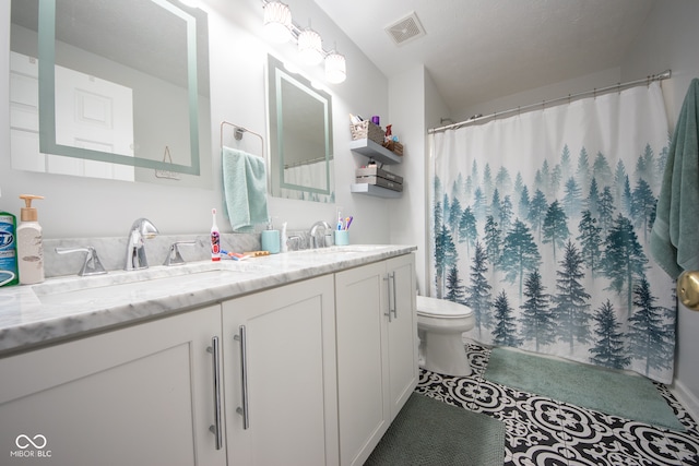 bathroom with toilet and vanity