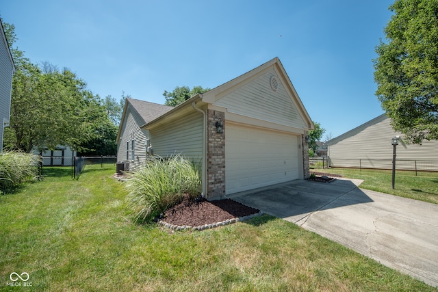 view of side of property featuring an outbuilding, a yard, and a garage