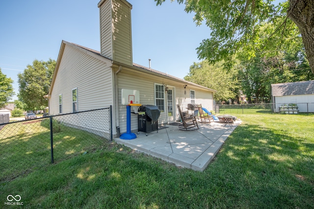 rear view of property with a patio and a lawn