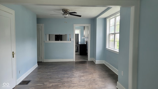 unfurnished living room with ceiling fan and dark hardwood / wood-style floors