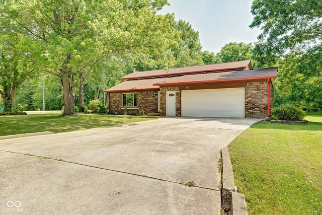 view of front facade with a front yard and a garage