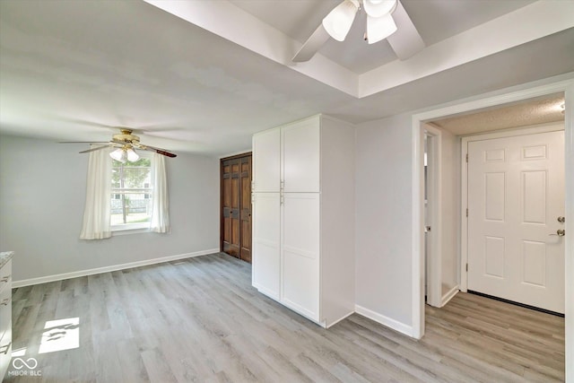 empty room featuring ceiling fan and light wood-type flooring