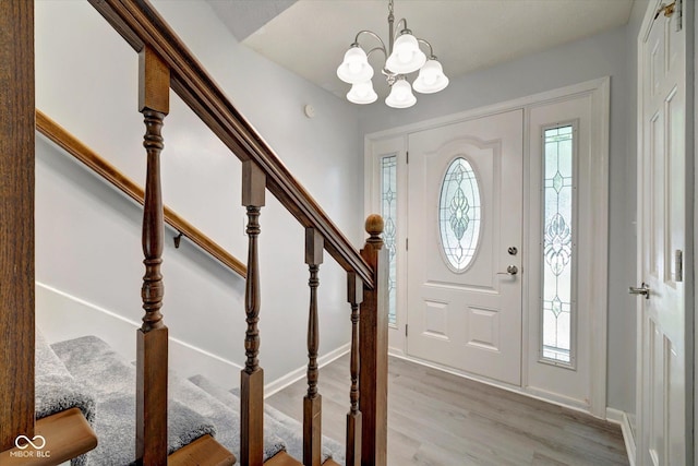 foyer featuring light wood-type flooring and an inviting chandelier