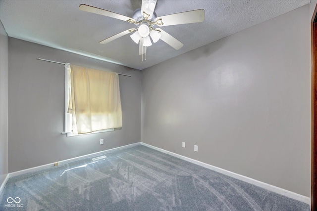 carpeted empty room with ceiling fan and a textured ceiling