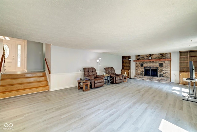 living area with light hardwood / wood-style flooring and a textured ceiling