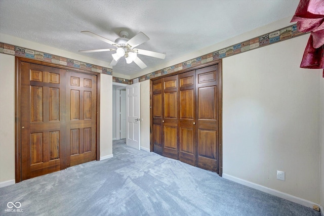 unfurnished bedroom featuring carpet, ceiling fan, a textured ceiling, and a closet