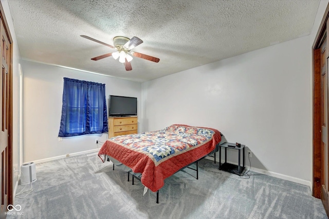 bedroom featuring carpet flooring, ceiling fan, and a textured ceiling