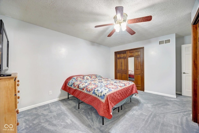 bedroom featuring ceiling fan, dark carpet, and a textured ceiling