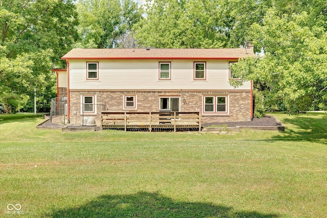 back of house featuring a deck and a yard