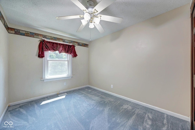 carpeted empty room featuring ceiling fan and a textured ceiling