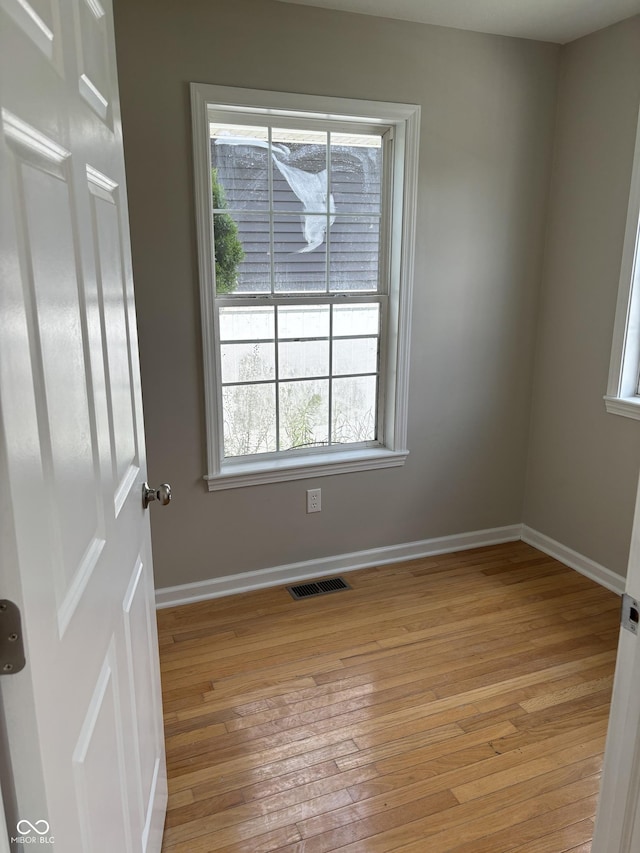 unfurnished room featuring light wood-type flooring