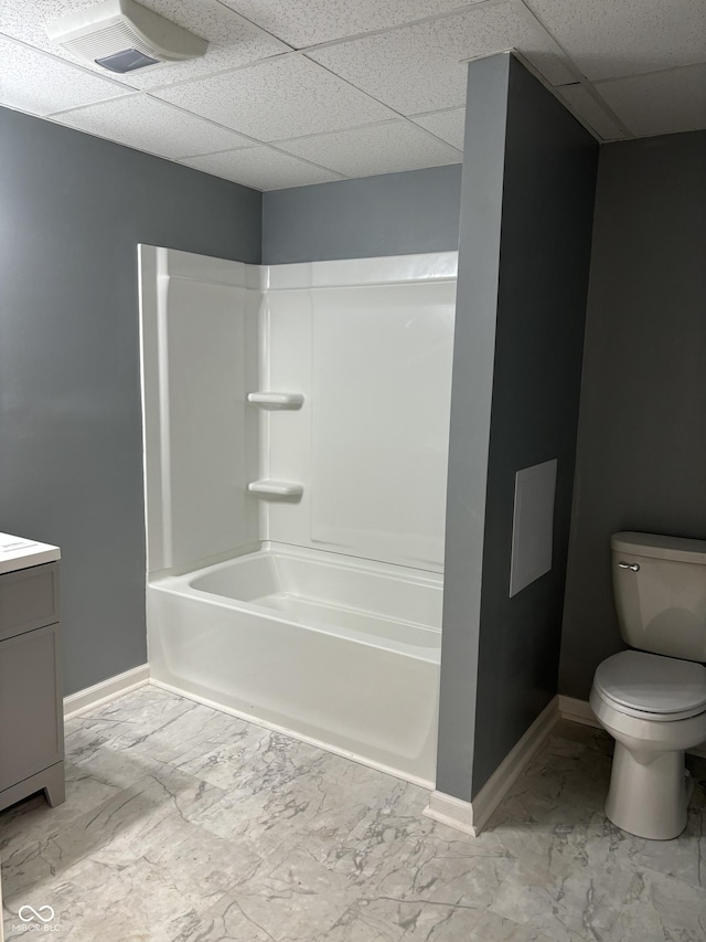 full bathroom with a paneled ceiling, vanity, toilet, and shower / washtub combination