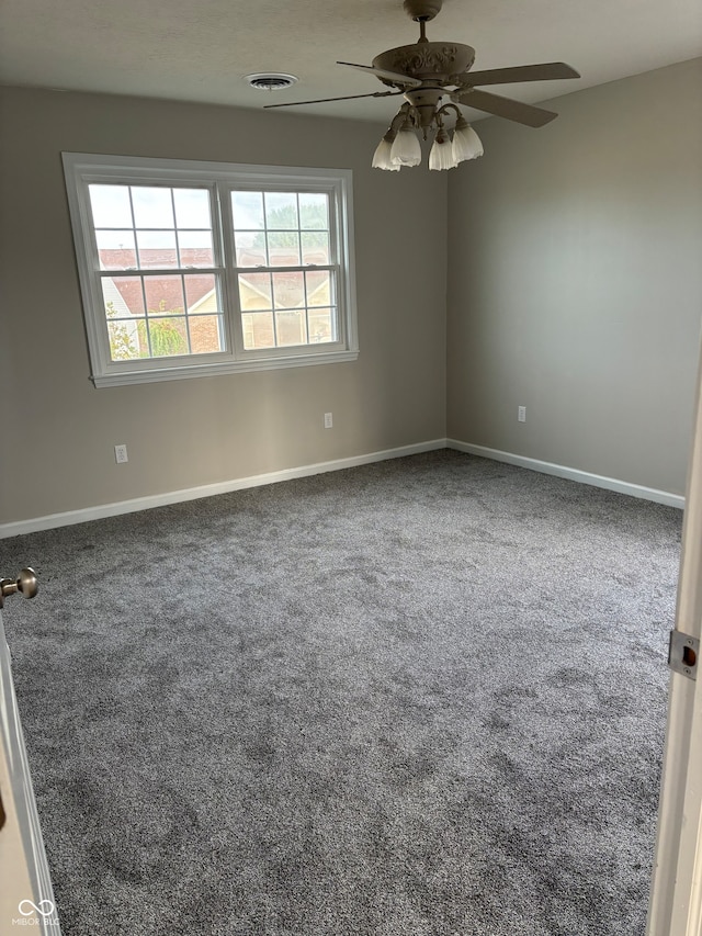 spare room featuring carpet and ceiling fan