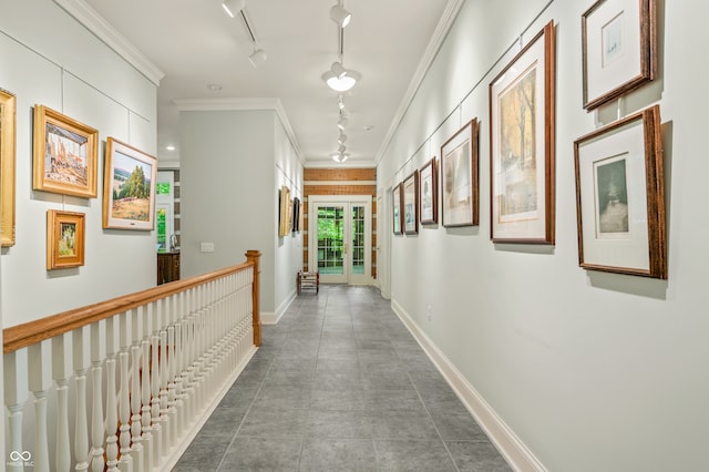 corridor featuring ornamental molding, track lighting, and tile patterned floors