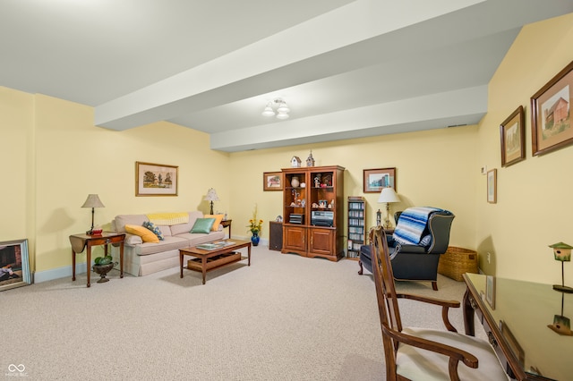 carpeted living room with beam ceiling