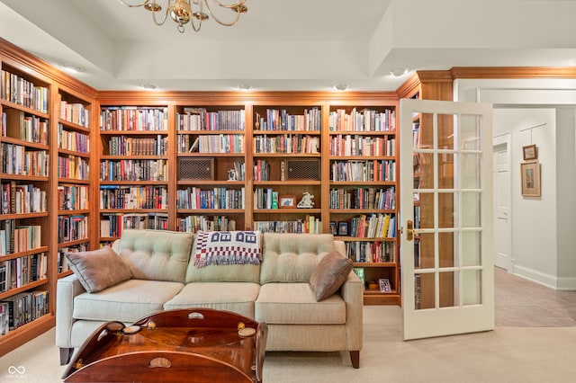 sitting room featuring light carpet and a chandelier