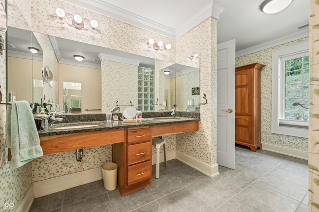 full bath with wallpapered walls, crown molding, and a sink