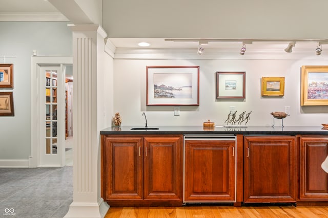 bar with ornate columns, rail lighting, sink, and ornamental molding