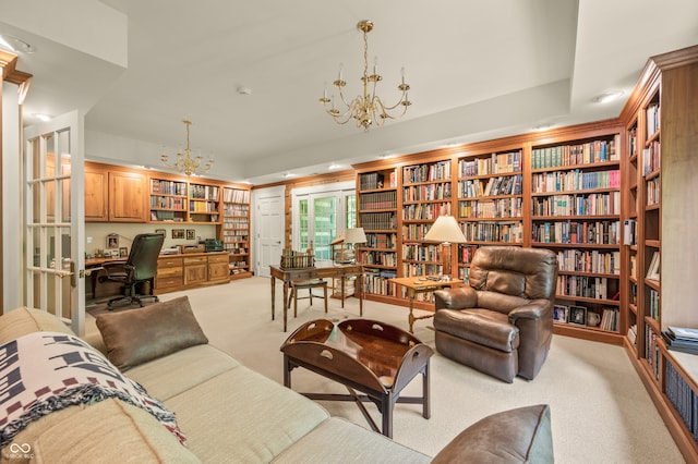 living room with light carpet and a chandelier