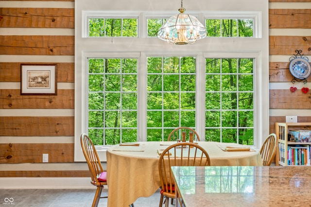 dining area with tile patterned flooring and a chandelier