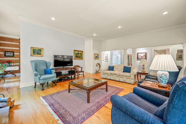 living room featuring brick wall, light wood-type flooring, and ornamental molding