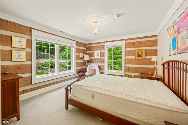 carpeted bedroom with wood walls and crown molding