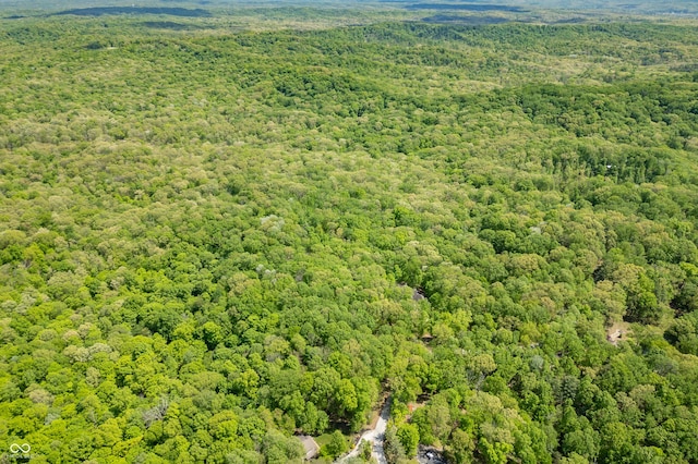 birds eye view of property with a forest view