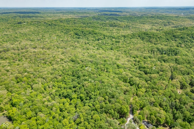 birds eye view of property featuring a view of trees