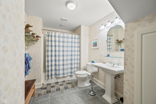 bathroom featuring toilet and tile patterned floors