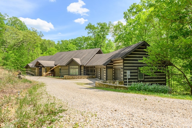 log home featuring a garage and driveway