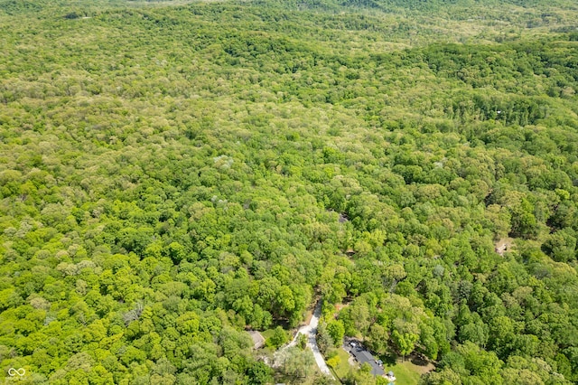 birds eye view of property featuring a wooded view