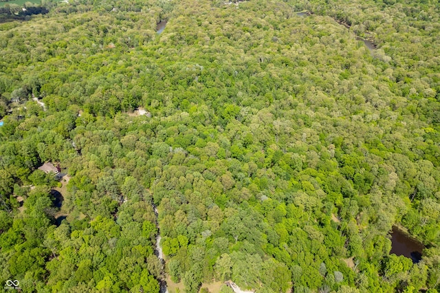 birds eye view of property featuring a wooded view