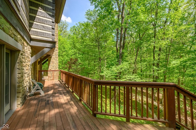 wooden deck featuring a view of trees