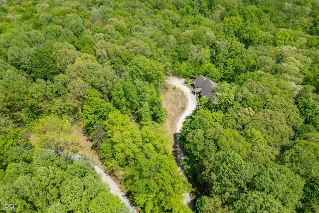 birds eye view of property with a view of trees