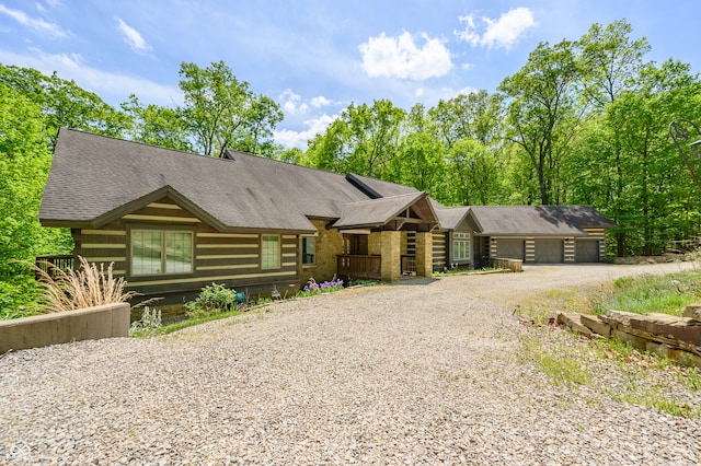 log-style house with a garage