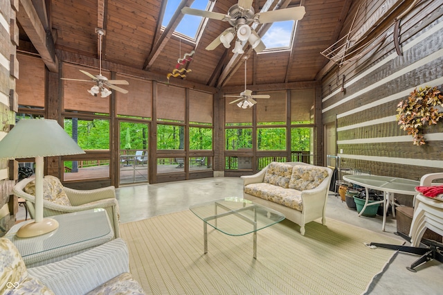 sunroom / solarium featuring lofted ceiling with skylight, wooden ceiling, and ceiling fan