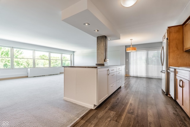 kitchen with white cabinetry, a center island, hanging light fixtures, dark hardwood / wood-style floors, and stainless steel fridge