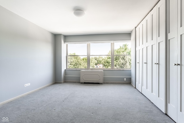 unfurnished bedroom with light colored carpet