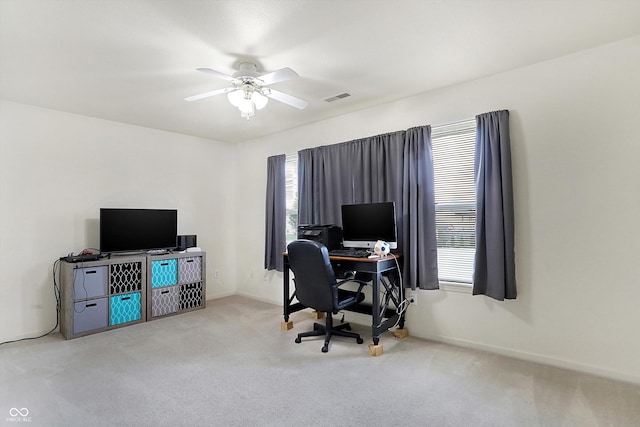 home office with light carpet and ceiling fan