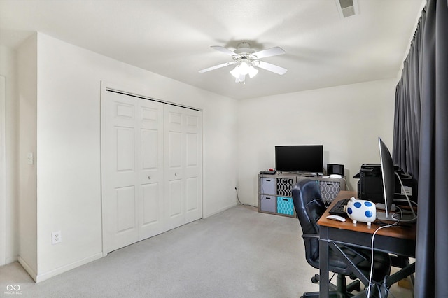 carpeted office space with ceiling fan