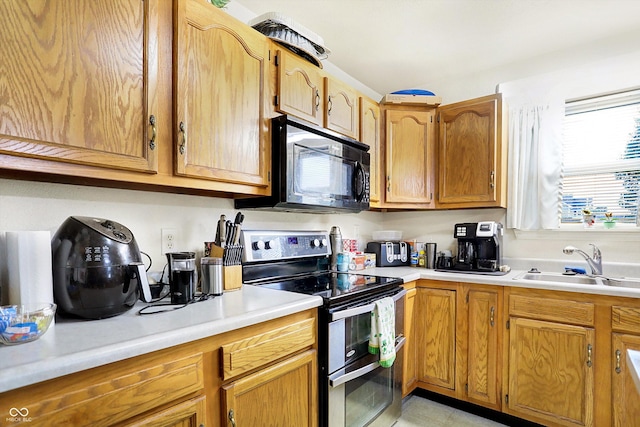 kitchen featuring sink and range with two ovens