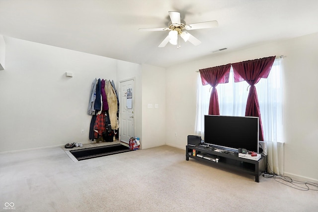 exercise room with ceiling fan and carpet floors