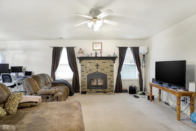 living room featuring carpet floors, ceiling fan, and a wood stove