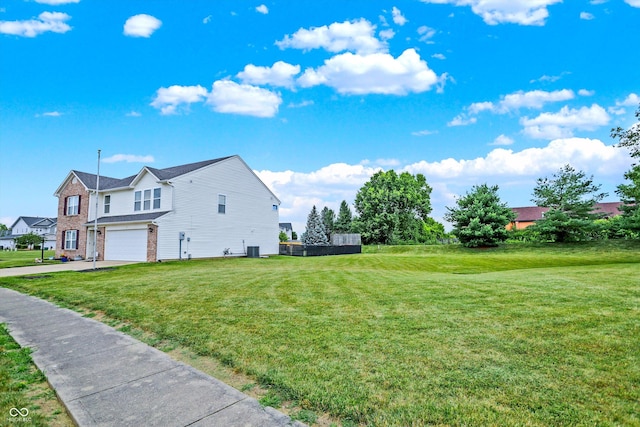 view of side of property with a garage and a lawn