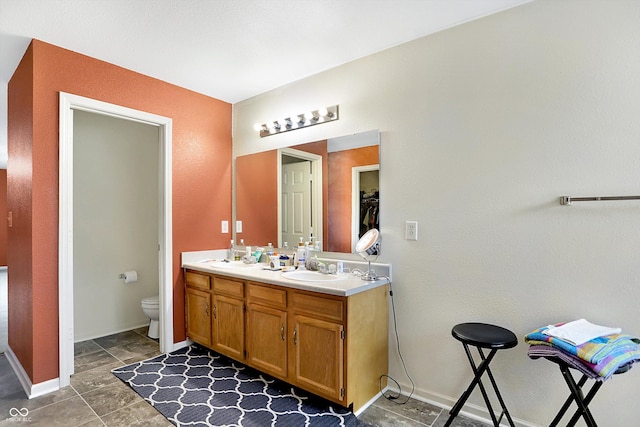 bathroom featuring toilet and vanity