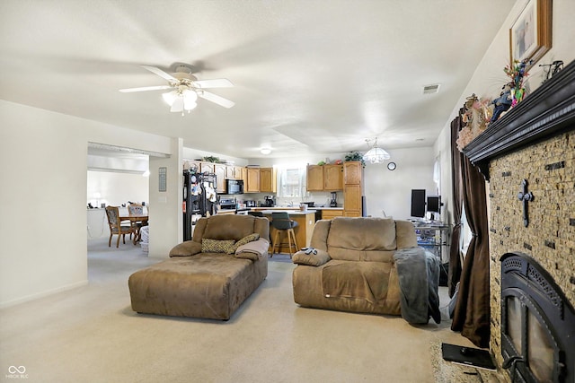 carpeted living room featuring ceiling fan