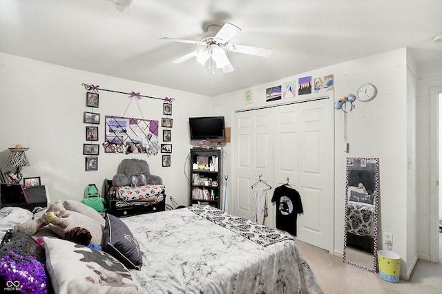 carpeted bedroom with ceiling fan and a closet